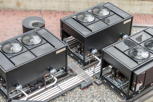 Commercial HVAC units on a gravel rooftop