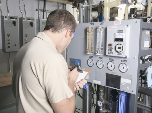 Commercial HVAC Repair - Commercial HVAC technician repairing HVAC system