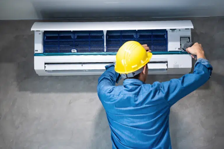 Technician man repairing ,cleaning and maintenance Air conditioner on the wall