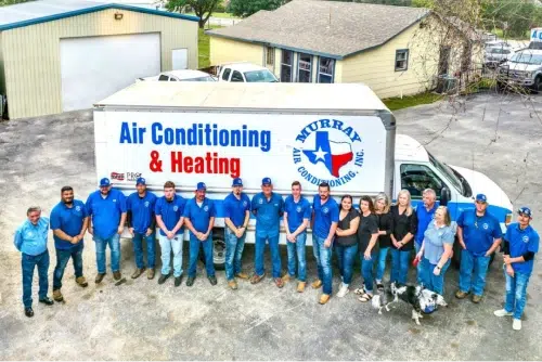 murray ac team standing in front of their work truck