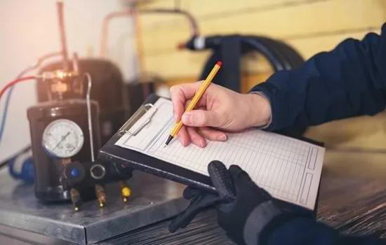 a person writing on a clipboard
