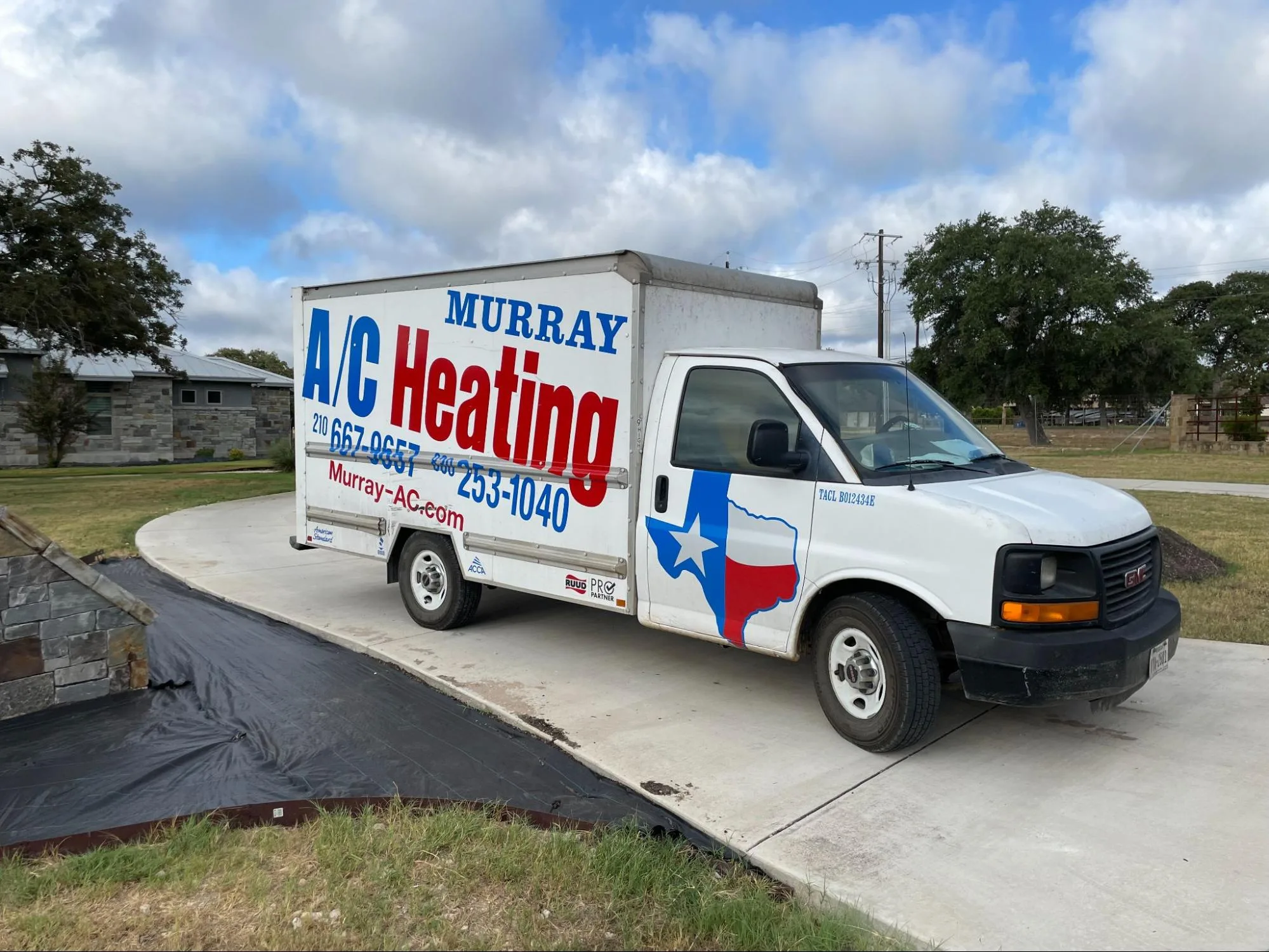 A white GMC box truck with 'Murray A/C Heating' branding in large blue and red letters