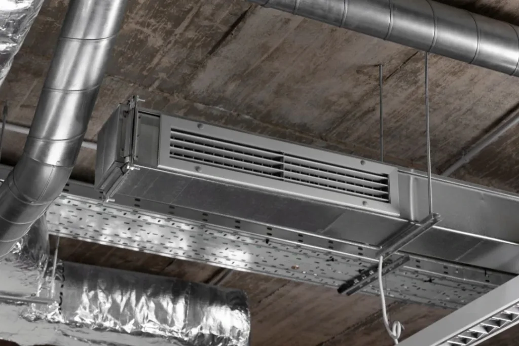 A ceiling-mounted HVAC duct system with exposed metal air ducts and insulation.
