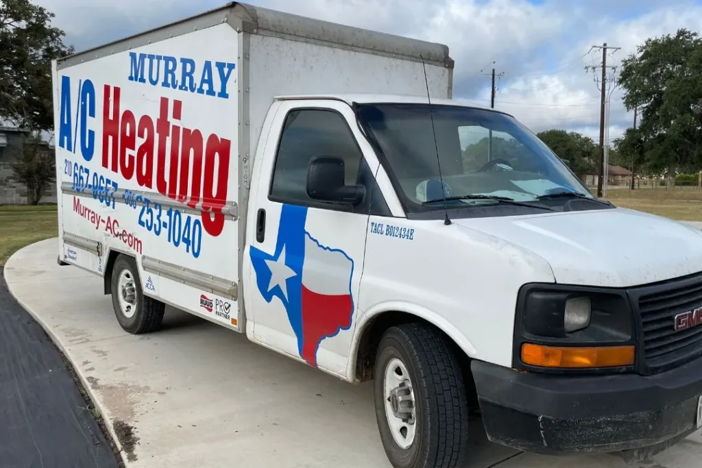 A white GMC box truck with 'Murray A/C Heating' branding in large blue and red letters