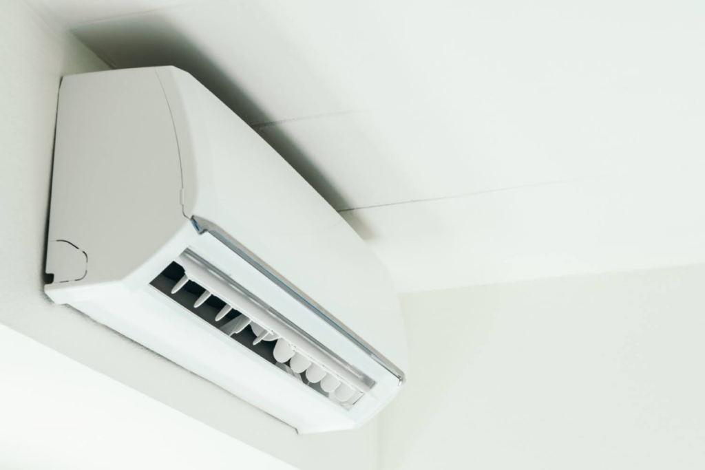 Wall-mounted indoor air conditioning unit operating in a modern room.