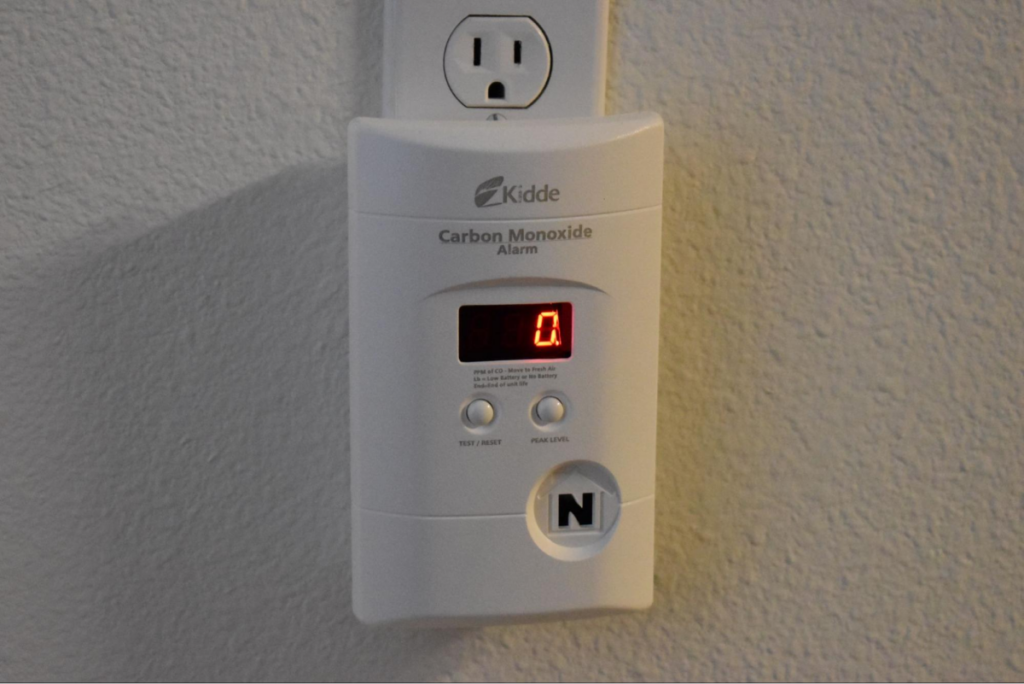 Carbon monoxide alarm plugged into a wall outlet.