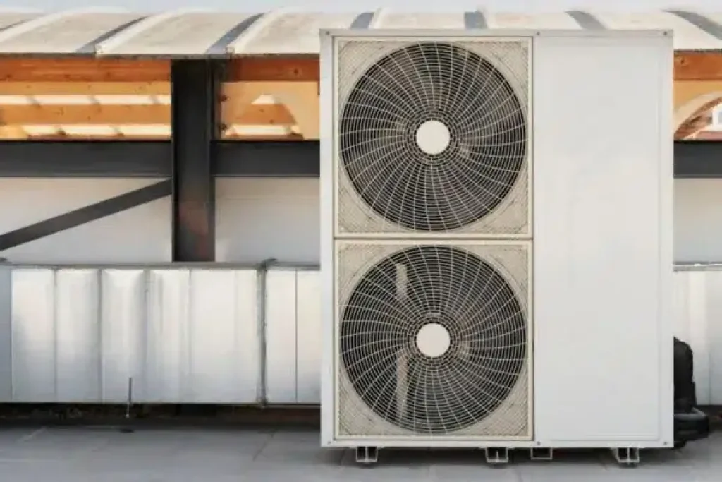 Large commercial air conditioning unit with dual fans installed on a rooftop