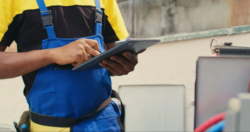 HVAC technician checking an air conditioning condenser