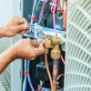 Technician repairing an HVAC unit