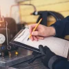 a person writing on a clipboard