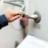 a person holding a handle to a pipe