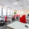 an office with red chairs and alluring interior